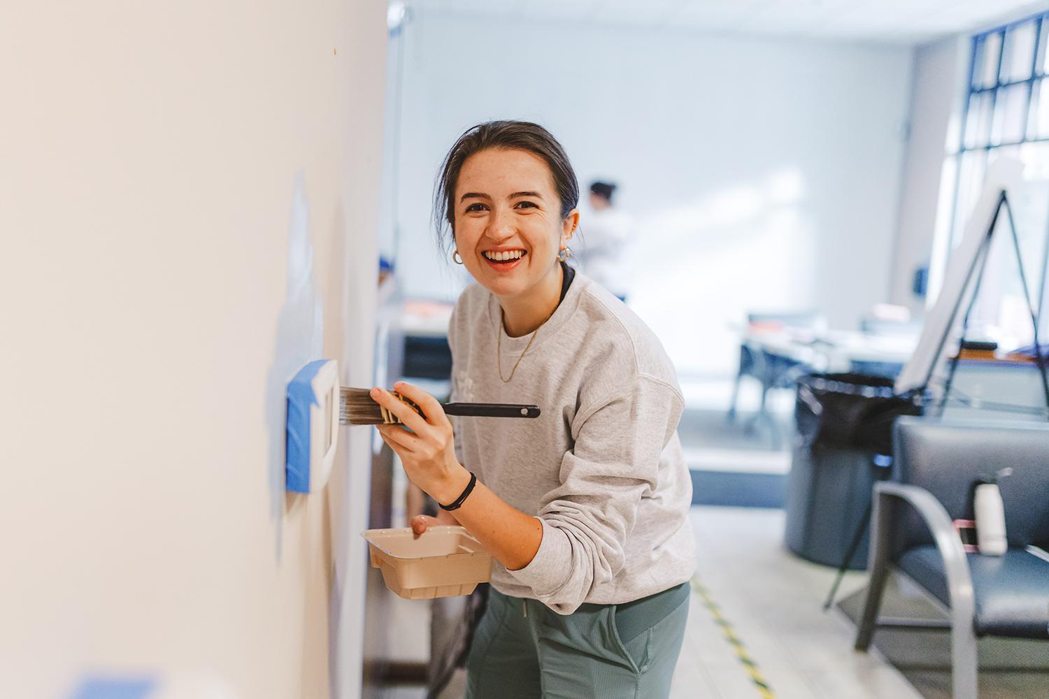 Volunteer paints a Kindering facility